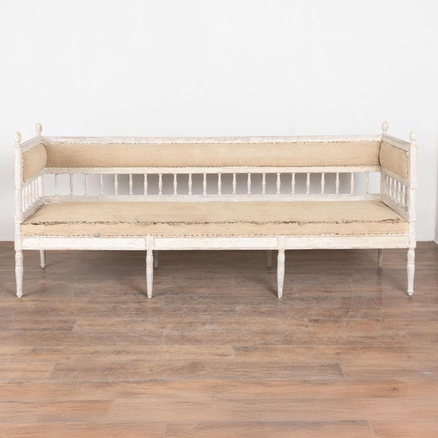Early 19th century Swedish Gustavian long bench crafted in pine. Turned and carved spindles form the sides and back, with...