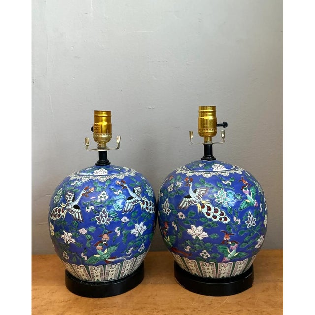 This pair of vintage table lamps features bulbous, ginger jar-style ceramic bodies finished in a deep cobalt blue, each...