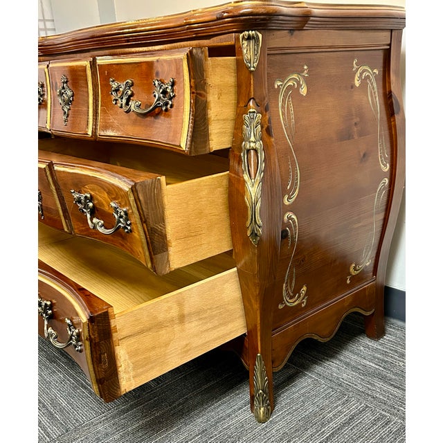 Solid knotty pine three drawer French Bombay style chest by Pulaski Furniture. Beautiful wood grain, hand painted side...