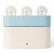 A horizontal, cream-lacquered wood and metal case, topped with an overhanging blue band that reveals three bare bulbs:...