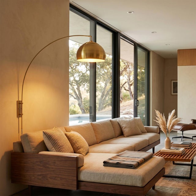 The Half Dome Wall Mounted Arc Lamp is a modern lighting solution designed by Peter Morelli in 1960. This lamp features a...