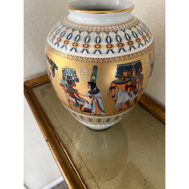 Bring the timeless allure of Egyptomania into your space with this striking limited-edition porcelain vase from renowned...