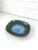 Large ceramic vide-poche or low bowl in olive green tones with an impressive blue flame in the center. The blue effects...