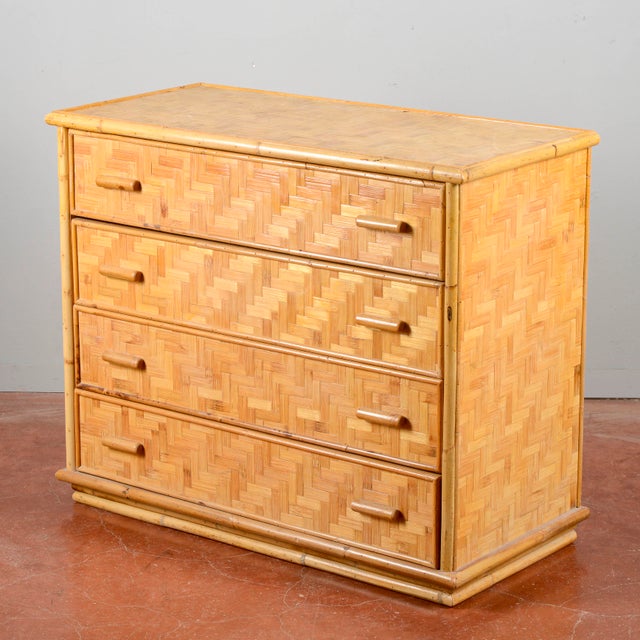 This bamboo and wicker dresser is a distinctive piece of modern antiques, likely dating to the 1960s or 1970s, embodying...