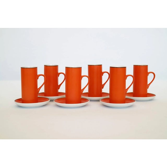 Set of six cups and dishes in original packaging. Signed