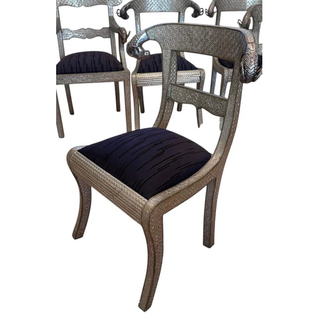 Set of 10 Moroccan Metal Clad Rams Head Dining Chairs. The set includes two host arm chairs and 8 armless side dining chairs.