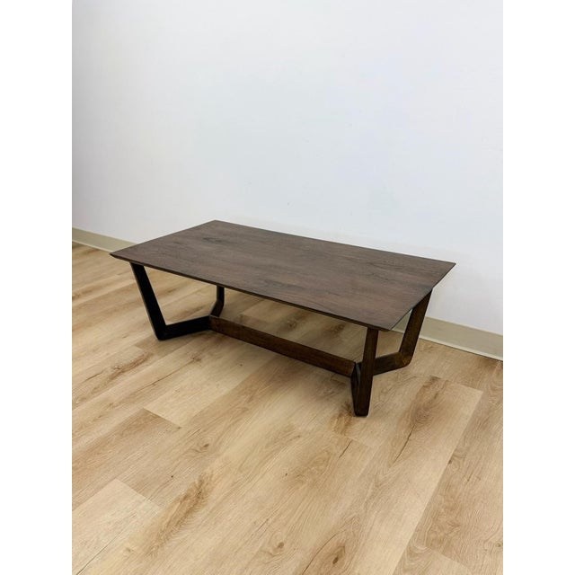 This vintage style coffee table from Williams Sonoma Home showcases a rich dark walnut finish with clean, tailored lines...