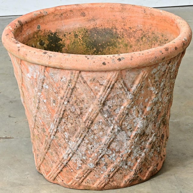 A 20th-century English terracotta planter with a basket weave or lattice pattern and thick, rolled rim to add a touch of...