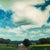Camp Road by Michael Miller | Oil on Panel Landscape with a road and distant houses under a cloudy sky For Sale