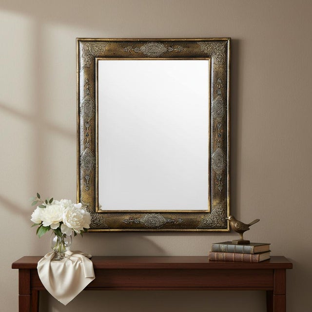 Dimensions: 24" W x 1" D x 30" H This solid wood mirror frame is accented with hand painted embossed metallic paint and...