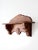 An early 20th-century folk art wall shelf featuring a shaped crest, carved rosette detailing, and architectural brackets....