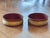 A matched pair of 19th century red wine coasters with a deep red interior and gilt-decorated exterior band. Circular form...