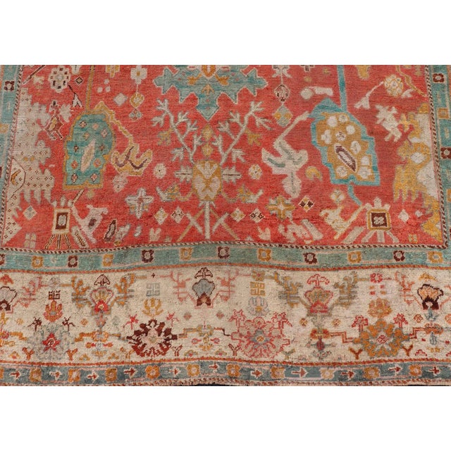 Early 20th Century Antique Turkish Oushak in Tribal Motifs in Soft Coral Blue Marigold and Cream For Sale - Image 10 of 13