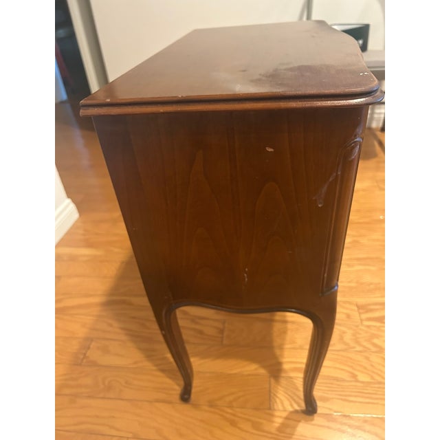 Vintage side table crafted in the French provincial style featuring cabriole legs, a softly serpentine apron, and ornate...
