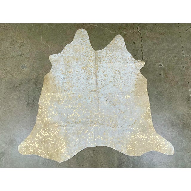 This striking Brazilian cowhide features an acid washed gold metallic finish. Adds a pop of color to the floor, as a throw...