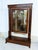 An elegant 19th century mahogany psyche or dressing mirror, designed in the Empire style and enriched with decorative gilt...