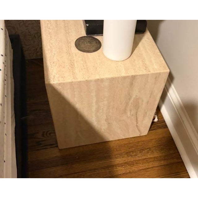 An exquisite matched set of two solid travertine cube side tables, heavily showcasing the clean geometric lines and...