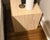 An exquisite matched set of two solid travertine cube side tables, heavily showcasing the clean geometric lines and...