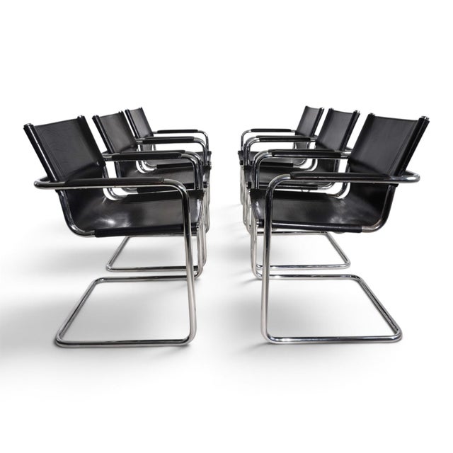 An impressive set of six Matteo Grassi Visitor Chairs, where black saddle leather and gleaming chrome create a striking,...