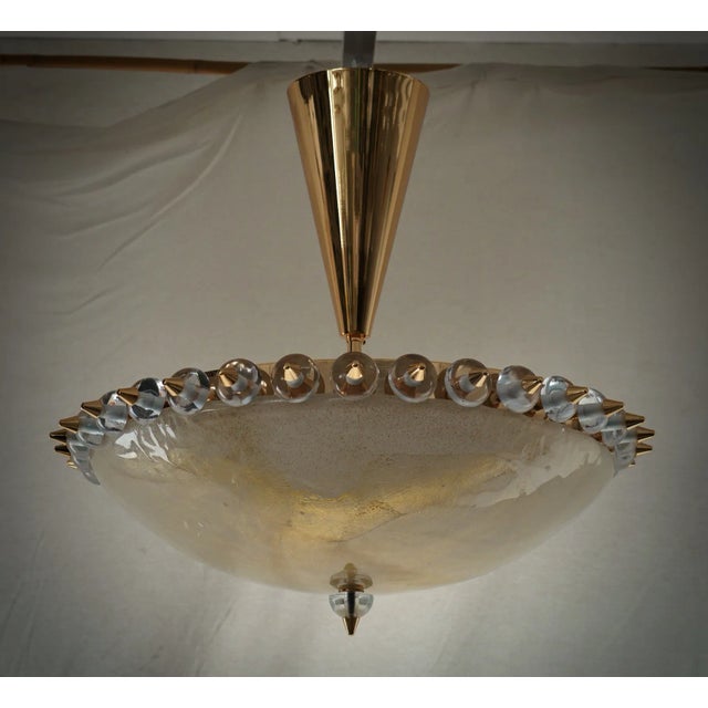Out of the ordinary chandelier from Murano glassworks, elegant golden colour, very original design. The Murano furnaces...