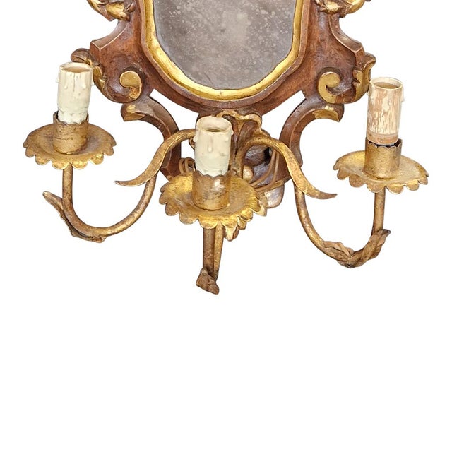 Set of four three-light Venetian fans, in carved, lacquered and gilded wood, with a small central mirror, late 19th-early...