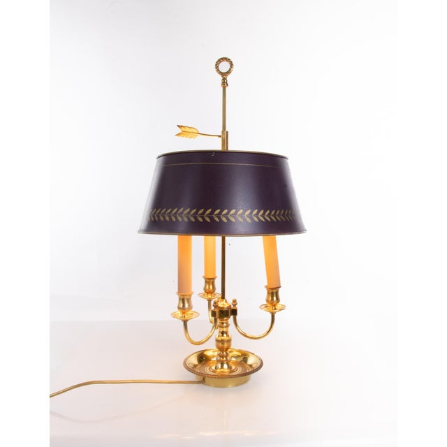 Elegant french bronze louis xv style bouillotte lamp with an adjustable painted metal shade and three electrified candle-...