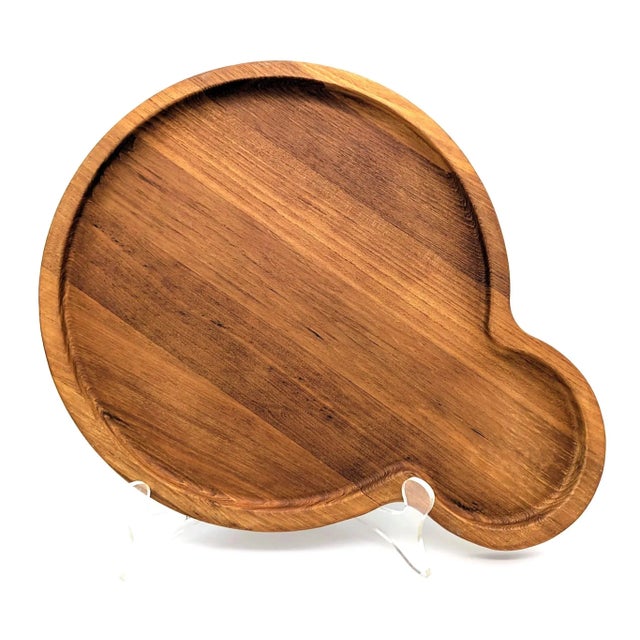 Offered is a bubble-shaped Teak wood tray designed by Jens H Quistgaard (marked JHQ for Dansk and made in Malaysia) made...