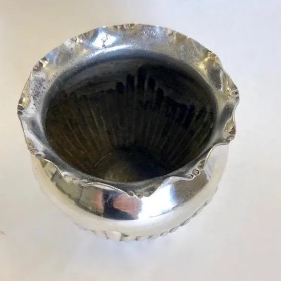 Victorian silver plated flower pot with a ruffled edge and flutter decoration surrounding the vase.
