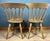 Beautiful vintage pair of chairs in a farmhouse-style beech dining design. They are often referred to as slat-back or...