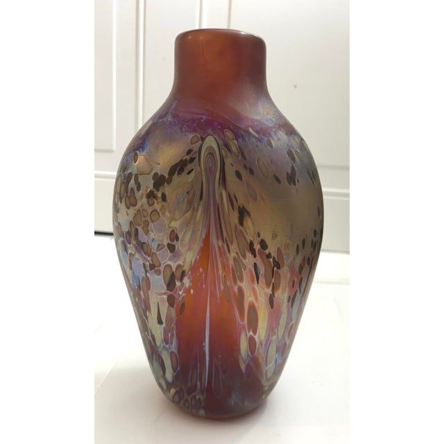 Loetz style Hand blown iridescent studio art glass vase. Color cranberry ruby base color multi colored pulled pattern and...