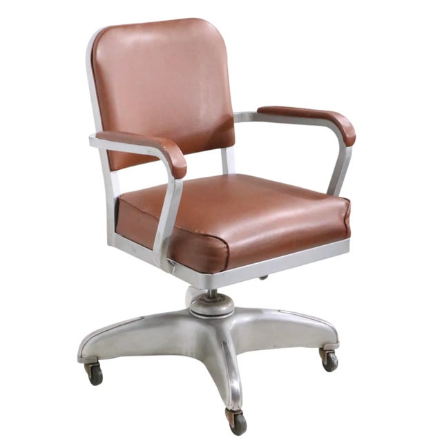 Swivel tilt office, desk chair constructed of aluminum, chrome, and vinyl. The chair isn adjustable in height, it also...