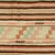 This Turkish kilim, handwoven in the 1940s, showcases a captivating blend of stripes and geometric patterns.