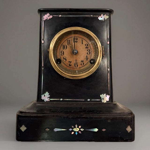 This listing is for an antique American mantel clock. This clock has a cast iron case with nice pearl inlay. It measures...