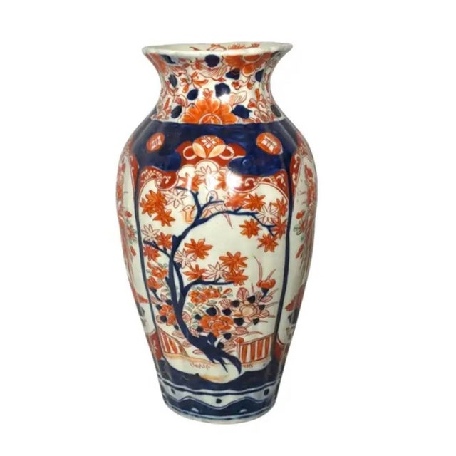 Japanese Imari Porcelain Vase. Vase features a flared rim, baluster-form body, and is hand-painted with flowering trees,...