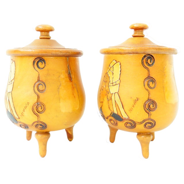 Delightful, artisan made wooden vessels featuring intricate hand-tooled decoration. The olive jar shaped bowls are perched...