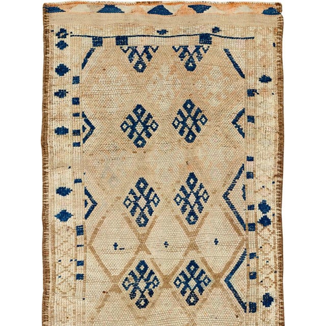 This mid-20th-century Turkish Anatolian runner presents a restrained geometric composition across an ivory and pale sand...