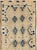 This mid-20th-century Turkish Anatolian runner presents a restrained geometric composition across an ivory and pale sand...