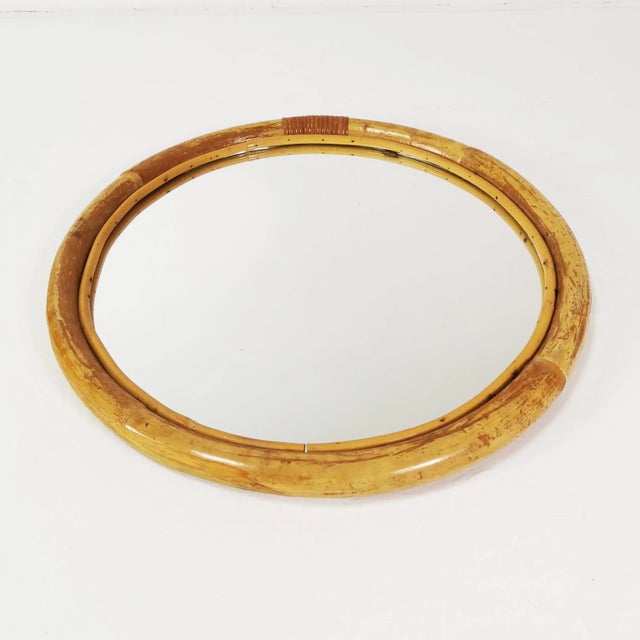Wall-mounted, round mirror, origin: Germany, 1970s. Frame made of bent bamboo. It has a pendant. Condition: good - has...