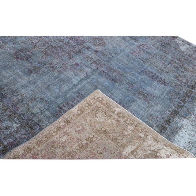 Beautiful Vintage Overdyed hand-knotted wool rug with a blue field. This Persian rug has purple and gray accents in an...