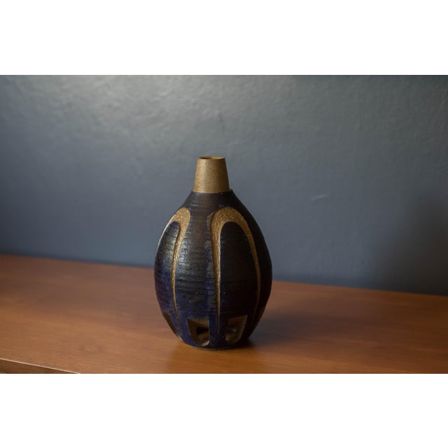 Vintage studio hand thrown stoneware ceramic bud vase, circa 1960's. This unique vessel features a sculptural stoneware...