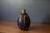 Vintage studio hand thrown stoneware ceramic bud vase, circa 1960's. This unique vessel features a sculptural stoneware...