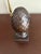 This cast metal pineapple finial garniture statue features a rich bronze-tone patina atop a stepped square pedestal base....