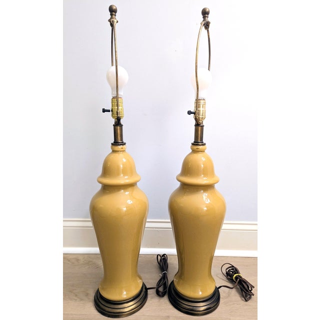 This pair of vintage ginger jar table lamps are estimated to be from the mid-to-late 20th century (60s-70s) and are a...