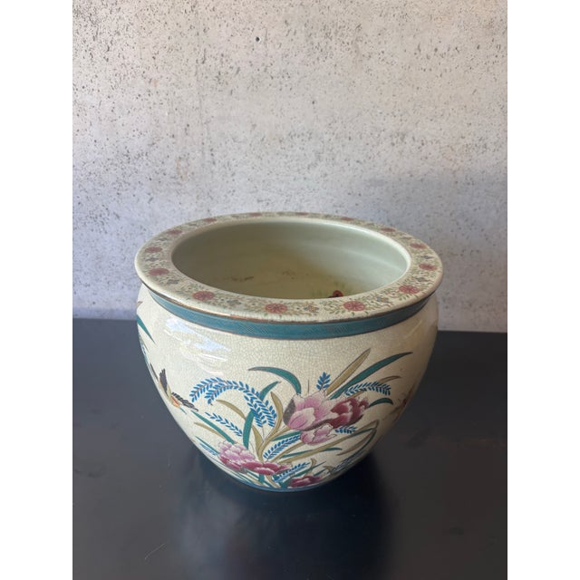 Vintage Chinese porcelain planter featuring a warm cream crackle-glazed ground with beautifully hand-painted peonies,...