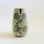 A mid century pottery vase. Tapered oval shaped. Matte light gray speckled glaze with a lovely painted design of leaves...