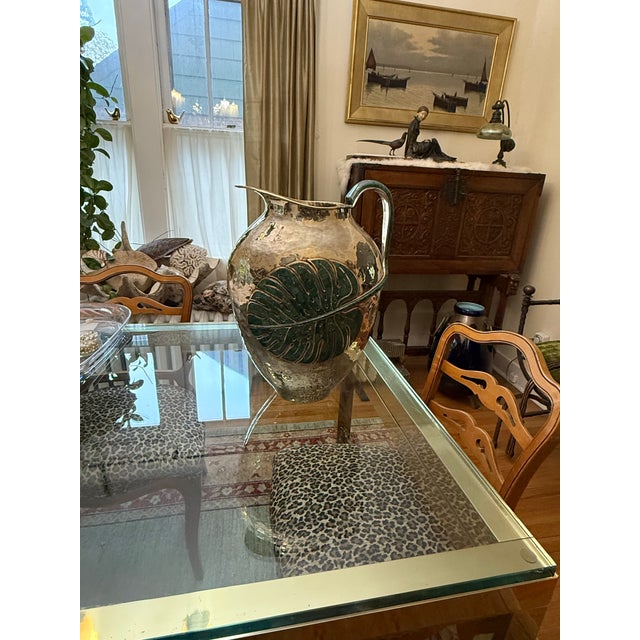 A stunning and exceptionally rare extra-large hammered silver plated water pitcher by renowned Mexican designer Emilia...