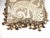 This pillow is made of vintage Fortuny fabric. It is lined with fringe and tassels.