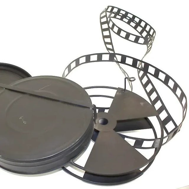 Curtis Jere “Director’s Cut’ wall art, signed 1995. Blue scupture of film reels is a reminder of the past for any theater...