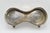 This is a silver plated stand. It can hold two wine bottles. It is from the early 20th century. It is not marked.