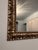 Ornate vine details carved into a large square gilt frame with a beaded border. This mantle mirror is stunning and stately...
